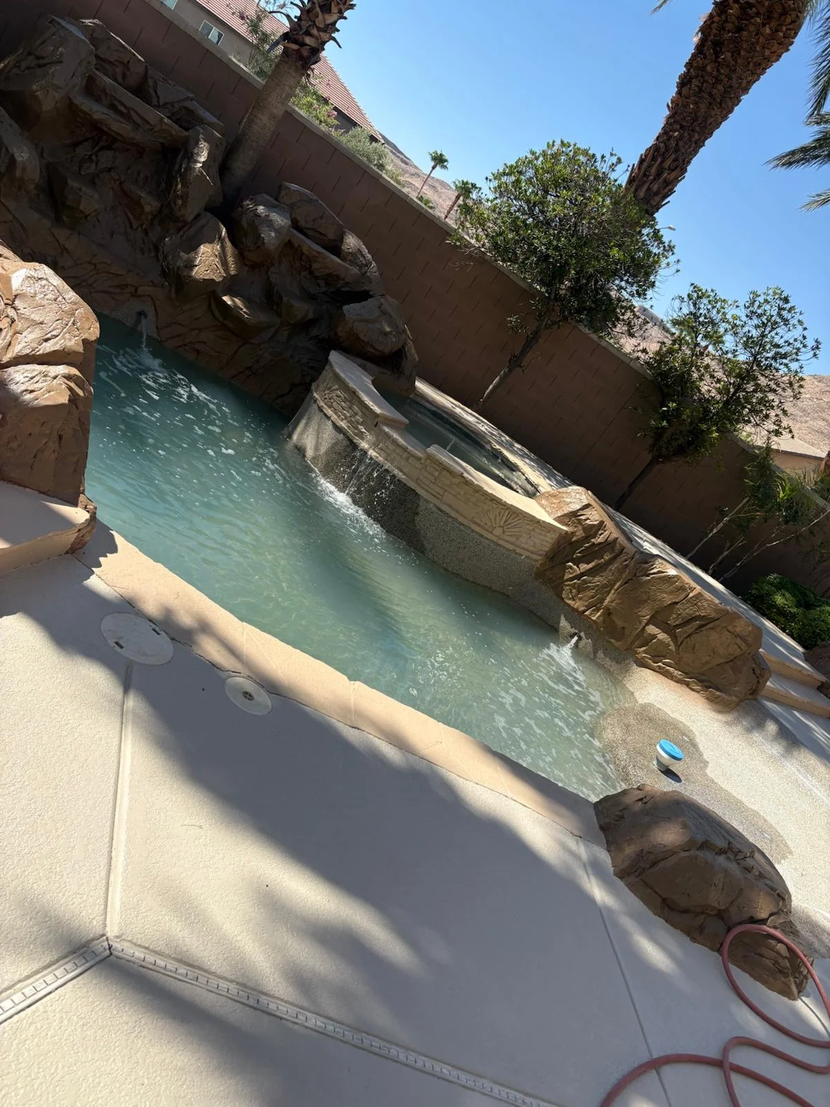 Backyard pool with rock waterfall feature in Las Vegas, NV